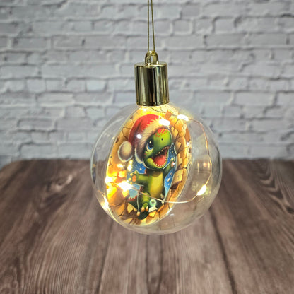 ❄️ Boule de Noël lumineuse à DEL en acrylique – Dino festif 🎄🦖