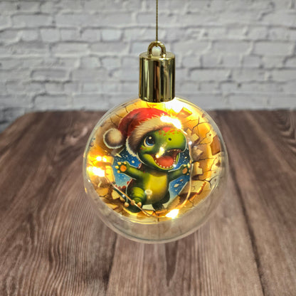 ❄️ Boule de Noël lumineuse à DEL en acrylique – Dino festif 🎄🦖
