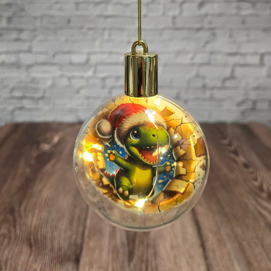 ❄️ Boule de Noël lumineuse à DEL en acrylique – Dino festif 🎄🦖